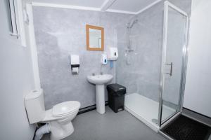 a bathroom with a shower and a toilet and a sink at Seaways glamping, Redwood in Great Driffield