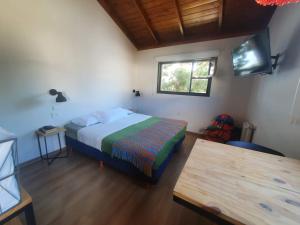 a bedroom with a bed and a desk at Trastienda Guest House in El Calafate