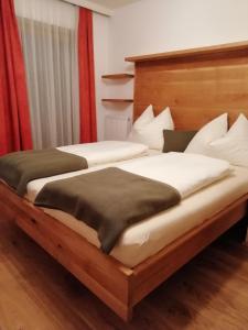 two beds sitting next to each other in a room at Haus Meißnitzer in Taxenbach
