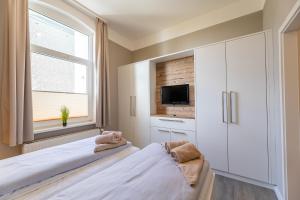 TV a/nebo společenská místnost v ubytování Haus Inselanker Kajüte 07 + 3 fotografie