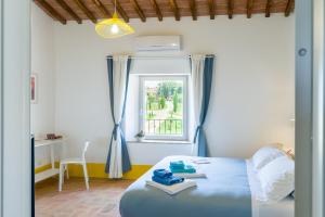 A bed or beds in a room at Tenuta La Santissima