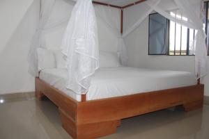 a bedroom with a bed with a canopy at Serranía Eco Lodge in San Juan de Arama