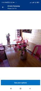 a picture of a table with a vase of flowers on it at Al Amin Homestay in Srinagar