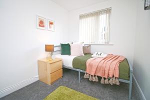 a small bedroom with a bed and a window at Dock House - 5 Bedroom House - Sleeps 7 in Newport