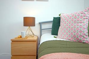 a bedroom with a bed and a nightstand with a lamp at Dock House - 5 Bedroom House - Sleeps 7 in Newport