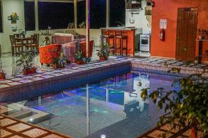 a swimming pool in the middle of a room with a kitchen at San Rafael Ecolodge in San Gerardo