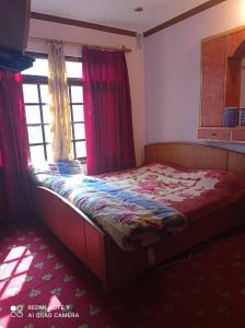 a small bed in a room with a window at Al Amin Homestay in Srinagar