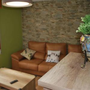 a living room with a couch and a table at Apartamento Rural Lago Enol in Cangas de Onís