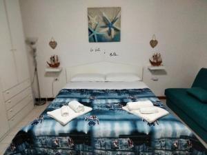 a bedroom with a bed with towels on it at La Gemma Amalfitana in Vietri sul Mare
