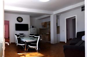 a living room with a dining room table and chairs at VILA VANESSIMO in Eforie Sud