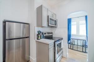 a kitchen with a stainless steel refrigerator and a window at Plush 2-bed apt in Riverside Heights! in Reno