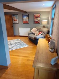 a living room with a couch and a table at Riverside 2 bed apartment Bewdley Worcestershire in Bewdley