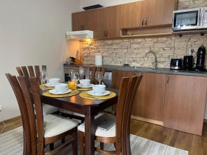 a kitchen with a table with chairs and a microwave at Bansko SPA Studio at Predela1 in Bansko