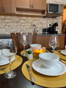 a table with plates and wine glasses on it at Bansko SPA Studio at Predela1 in Bansko +9 photos