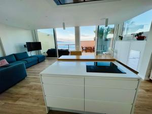 a kitchen with a white island in a living room at OvertheOcean Big terrace and XL Bed in Cabo Verde