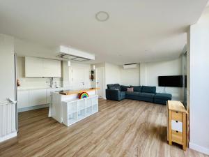 a large living room with a couch and a kitchen at OvertheOcean Big terrace and XL Bed in Cabo Verde