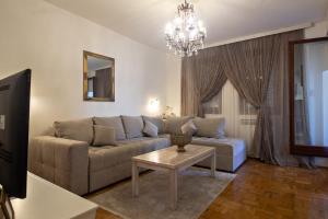 a living room with a couch and a table at Apartment Barby - Aleja in Banja Luka