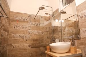 bagno con lavandino e doccia in vetro di Apartamentul 16 a Braşov