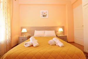 a bedroom with a bed with two pillows on it at A Nice Apartment- Corfu Town, Kanoni in Kanoni