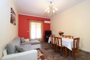a living room with a couch and a table at A Nice Apartment- Corfu Town, Kanoni in Kanoni