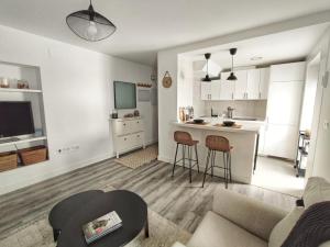 a living room with a couch and a kitchen at ARTE Playa la Caleta Grupo AC Gestion in Cádiz +19 photos