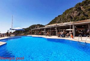 una grande piscina blu con una montagna sullo sfondo di Corfu Dream Holidays Villas 9-1 a Glifada (Glyfada)