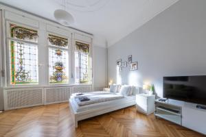 a bedroom with a bed and stained glass windows at Elisabeth Apartment on Váci Street in Budapest