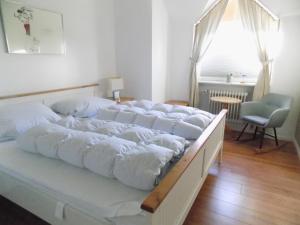 מיטה או מיטות בחדר ב-Sylter Apartments Wilhelmstrasse