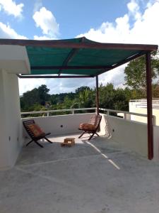 two chairs under a canopy on a roof at Departamento para 4 Personas Sueñitos en Bacalar in Bacalar