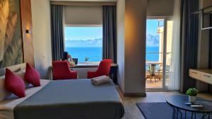 a hotel room with a bed and a view of the ocean at Letstay Panorama Suites in Antalya
