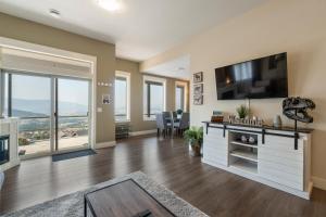 a large living room with a flat screen tv and a flat screen tv at Oh What A View! - Lower Suite in Vernon