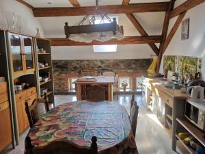 a kitchen with a table in the middle of a room at Noclegi nad neonet Bogatynia in Bogatynia