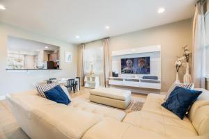 a living room with a couch and a tv at Gorgeous Home With Media, Disney Themed Kids Room Near Disney With Waterpark & Resort Access At Encore Resort - 771La in Kissimmee