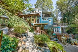 a blue house on a hill with trees at Flume's End in Nevada City