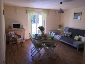 a living room with a table and a couch at Le Cocovert du Verdon in Riez