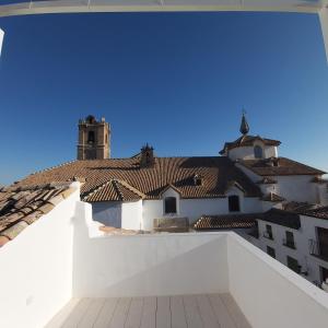 a view from the roof of a building with a clock tower at Casa Rural Plaza Santa Ana in Priego de Córdoba