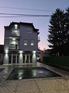 a building with a parking lot in front of it at Apartmani Marija in Vrdnik