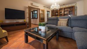 a living room with a couch and a tv at La Casa de Aljibillos by Toledo AP in Toledo