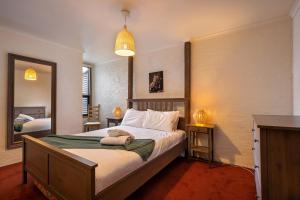 a bedroom with a large bed and a mirror at Snowgums 13 in Dinner Plain