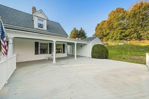 a house with a large driveway in front of it at Pool house in Plymouth