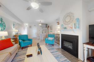 a living room with a couch and a fireplace at Mallard Lakes -- 158 Cardinal in Fenwick Island