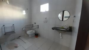 a bathroom with a toilet and a sink and a mirror at Pousada Subindo as Dunas in Canoa Quebrada +54 photos