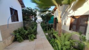 a courtyard of a house with a palm tree at Pousada Subindo as Dunas in Canoa Quebrada