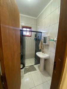 a bathroom with a toilet and a sink and a shower at RANCHO KWILL in Serra Negra +20 photos