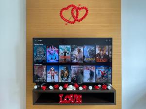 a book shelf with movies on it and a red heart at Private Jacuzzi Staycation at KL City 152 in Kuala Lumpur