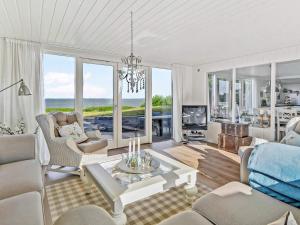 a living room with a couch and a table at 6 person holiday home in Vinderup-By Traum in Vinderup