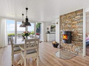 a dining room with a table and a fireplace at 6 person holiday home in Vinderup-By Traum in Vinderup