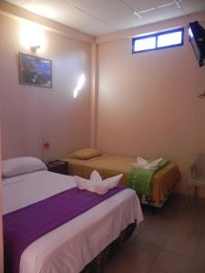 Postel nebo postele na pokoji v ubytování Hostal La Posada De Jose Carlos