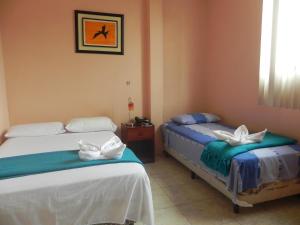 Säng eller sängar i ett rum på Hostal La Posada De Jose Carlos