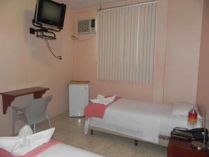 Postel nebo postele na pokoji v ubytování Hostal La Posada De Jose Carlos